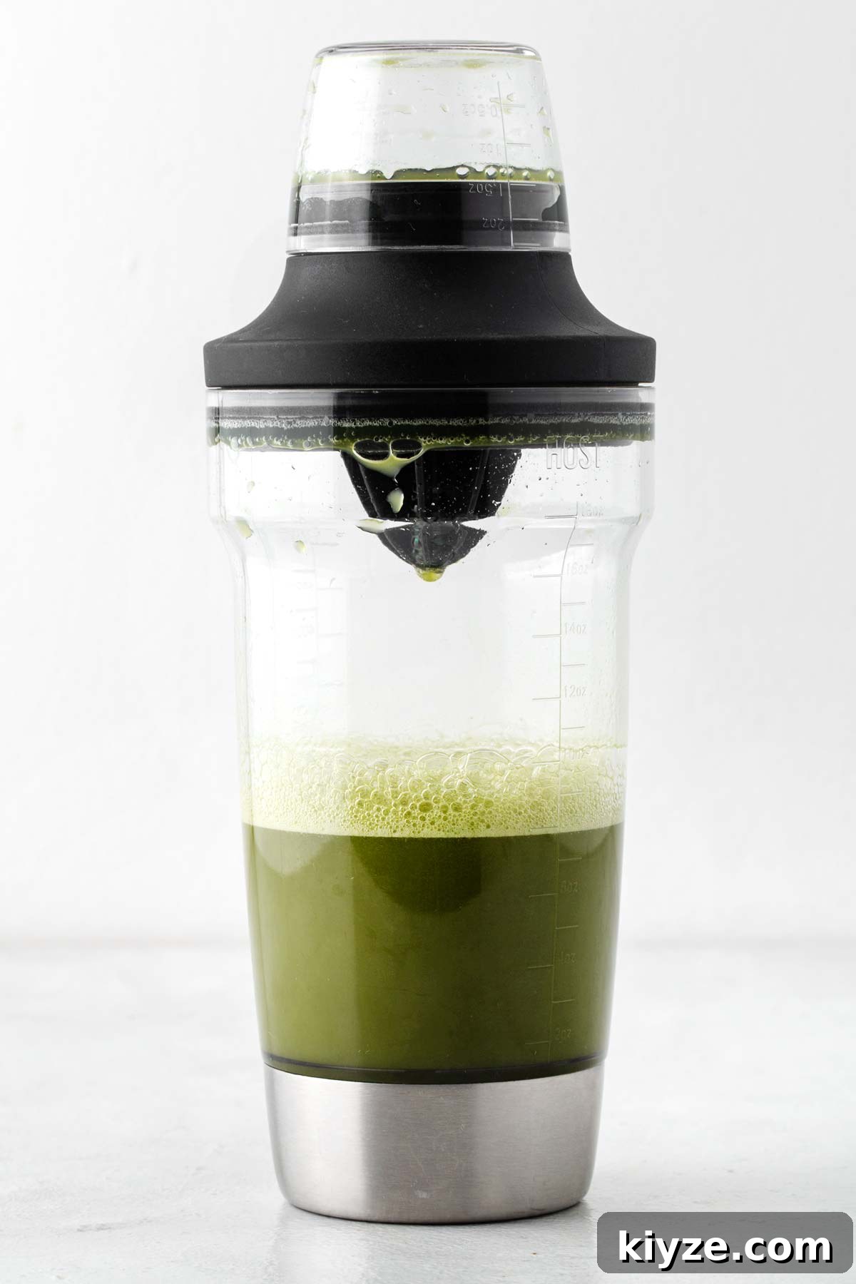 Iced Pineapple Matcha Latte Recipe: Refreshing Tropical Drink 7 Covered cocktail shaker with pineapple juice and matcha mixed together.