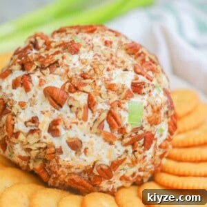 Classic Cheddar Cheese Ball Recipe for Parties & Holidays 7 Classic Cheese Ball on a plate with crackers
