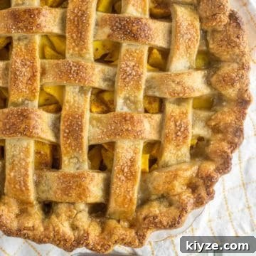 overhead shot of peach mango pie with lattice top crust