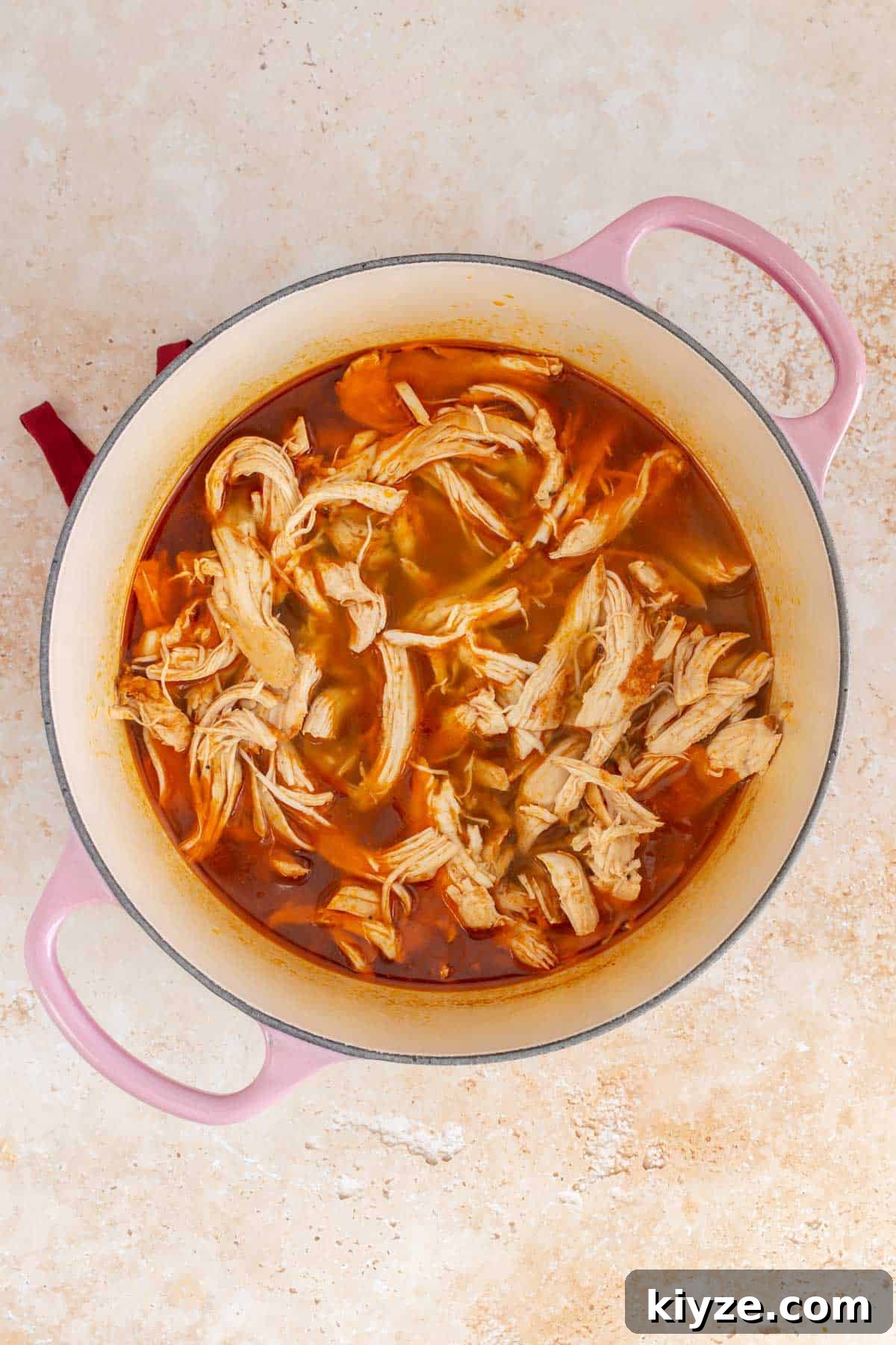 Shredded Chicken Made in a Dutch Oven: Tender Slow-Cooked Recipe 7 Overhead view of Dutch oven shredded chicken.