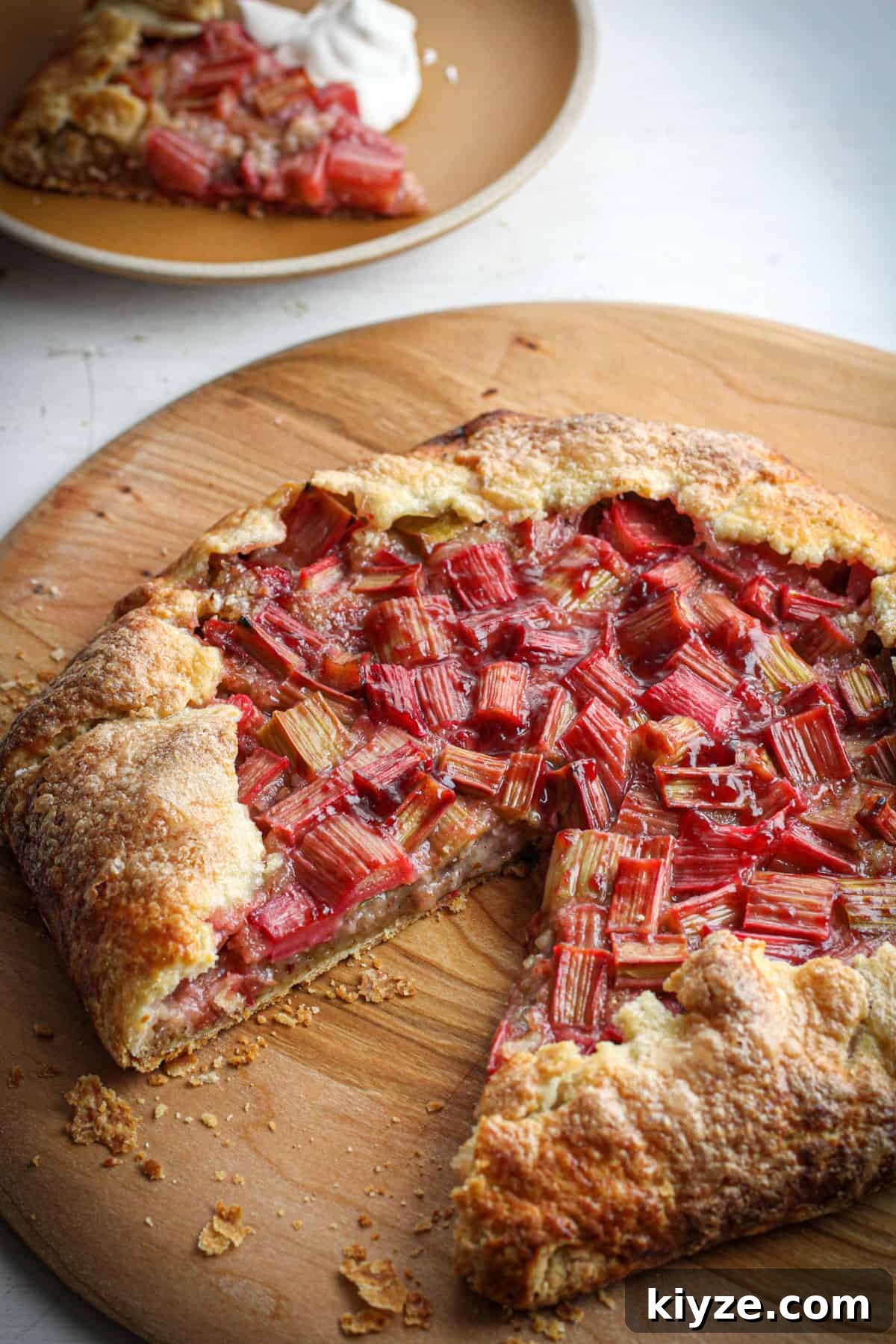 Butter Pie Crust Made in a Food Processor: Quick Recipe 8 A rhubarb galette on a wooden pizza peel with a slice taken out.