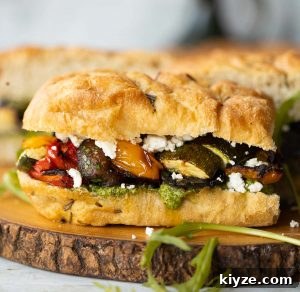 Focaccia Sandwich close up shot of focaccia sandwich on wooden board with filling showing