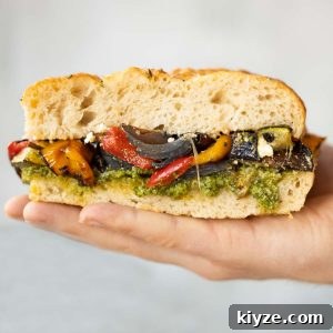 close up shot of hand holding sandwich flat showing filling