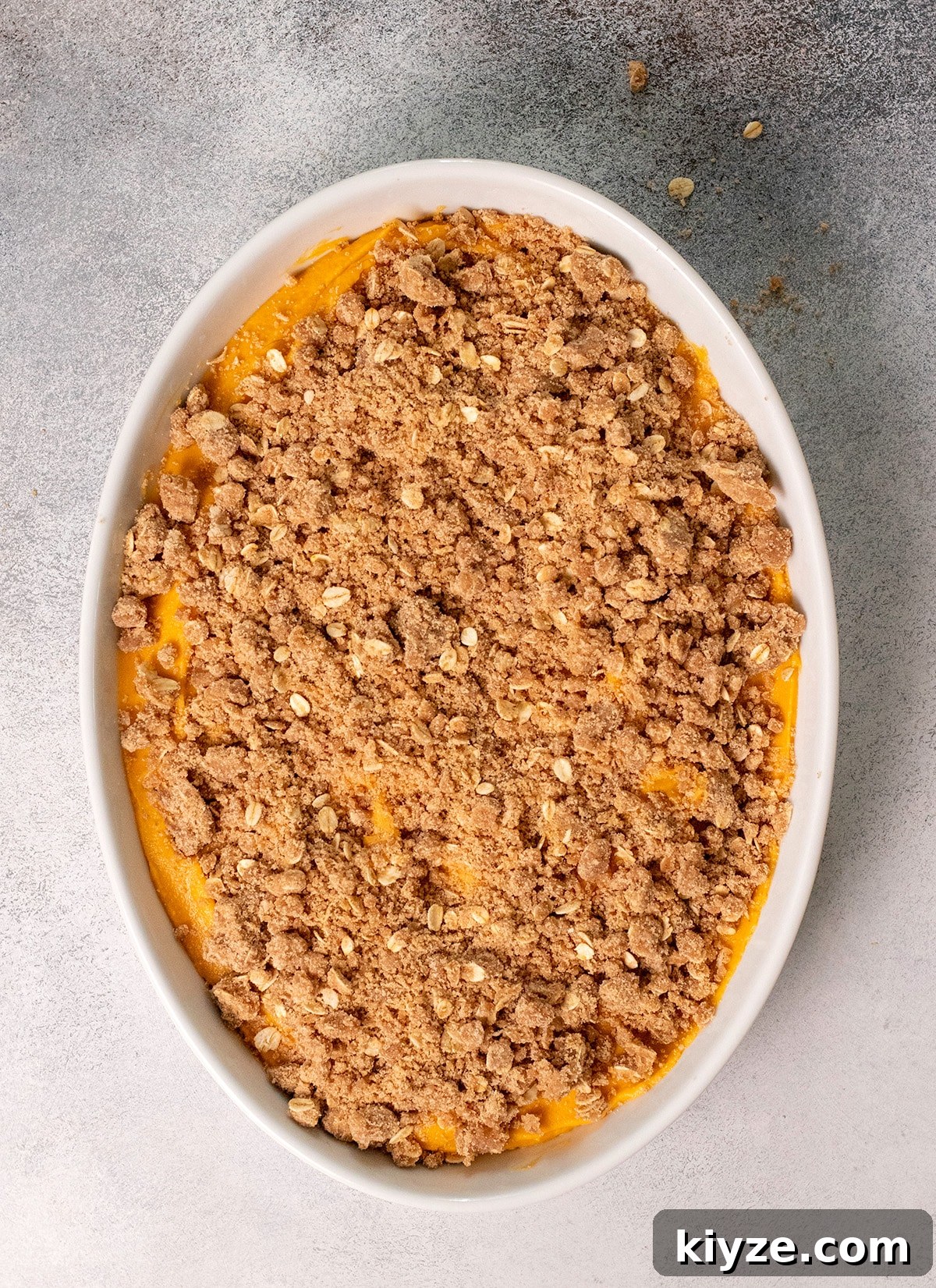 Gluten-Free Sweet Potato Casserole Recipe for Holidays 3 Sweet potato casserole unbaked in white baking dish overhead image