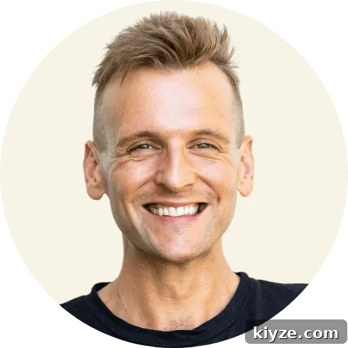 Authentic Baba Ganoush Recipe: Smoky Eggplant Dip Guide 2 Kaleb Wyse wearing a black shirt standing in front of a taupe background.
