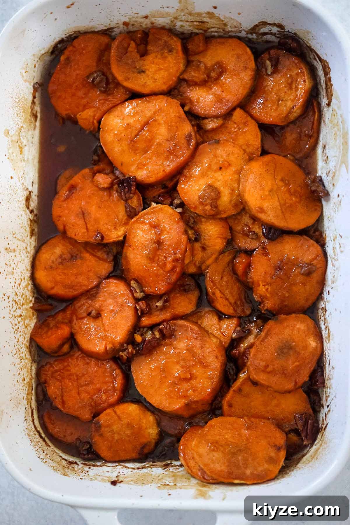 Bourbon-Glazed Candied Yams Recipe for Holiday Sides 5 Baked yams in a white 9x13 casserole dish.