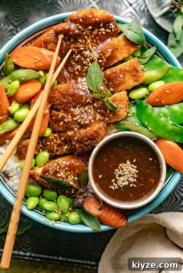 Mongolian Beef Noodles with Ground Beef and Scallions 12 teriyaki chicken, edamame beans, carrots, snow peas, and rice in a large bowl.