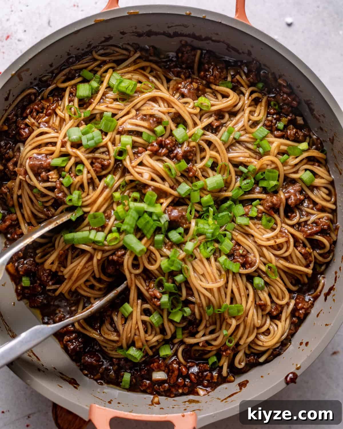 Mongolian Beef Noodles with Ground Beef and Scallions 7 noodles added to the ground beef mixture with scallions and sesame seeds on top.