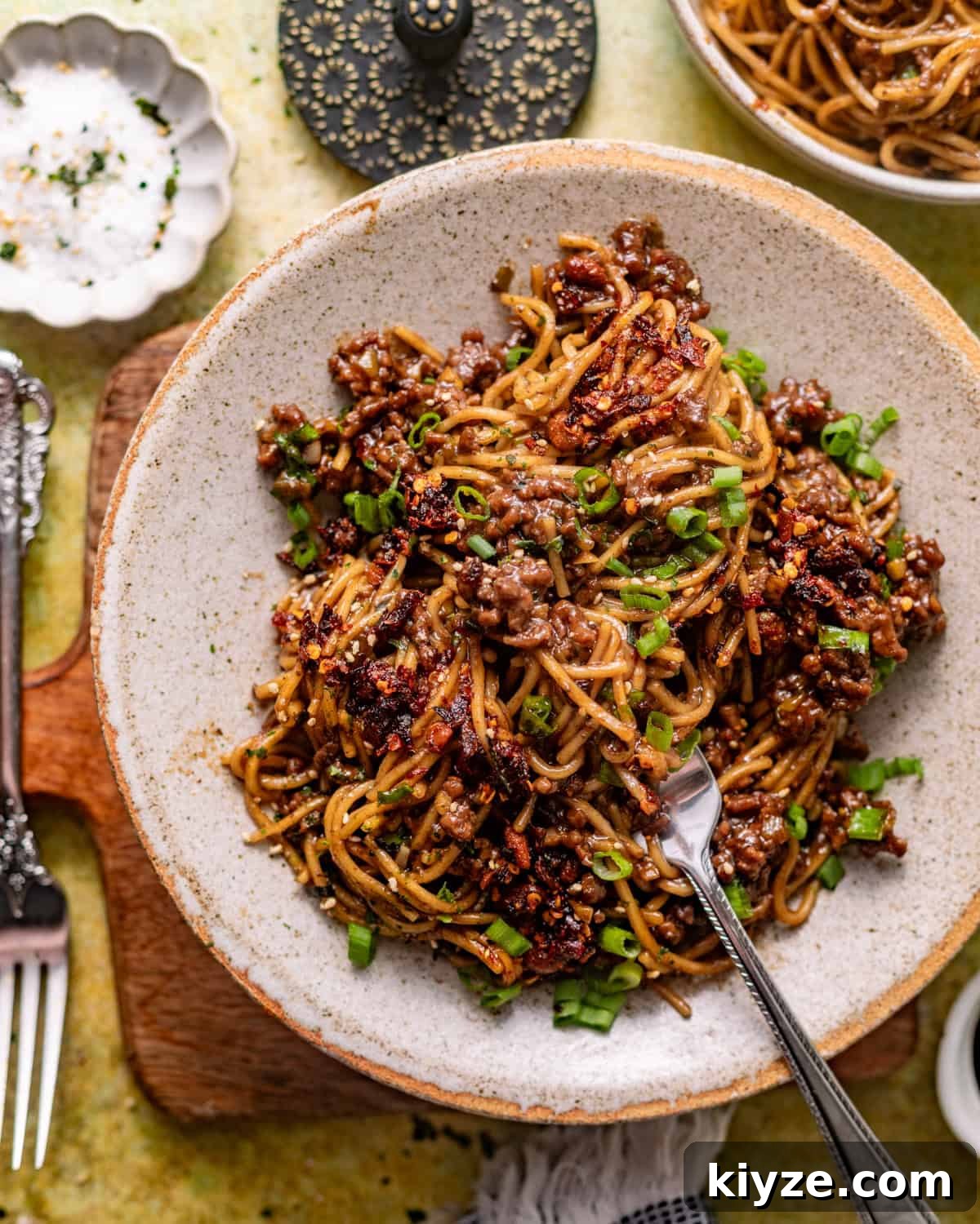 Mongolian Beef Noodles with Ground Beef and Scallions 8 overhead photo of mongolian ground beef noodles in a bowl with a fork.