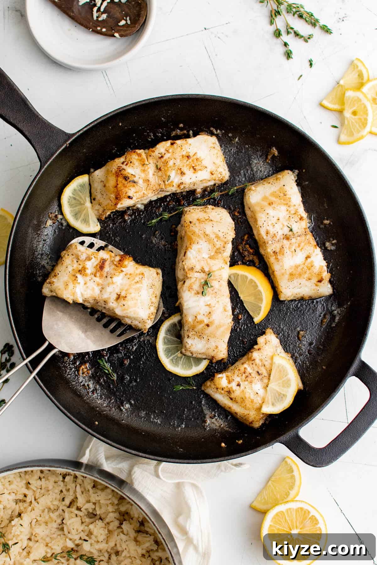 five slices of sea bass in a cast iron pan
