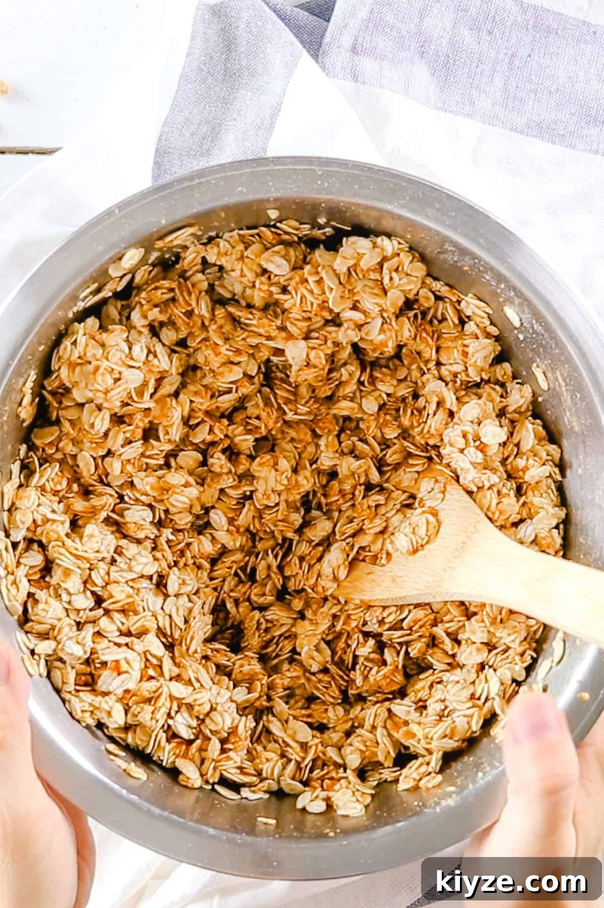 Pumpkin Spice Granola Recipe Made from Scratch 4 Stirring the ingredients for pumpkin granola in a big mixing bowl.