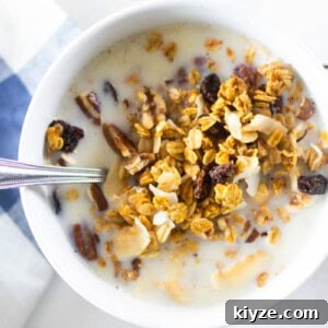 Pumpkin Spice Granola Recipe Made from Scratch 10 A bowl of homemade pumpkin granola with milk.