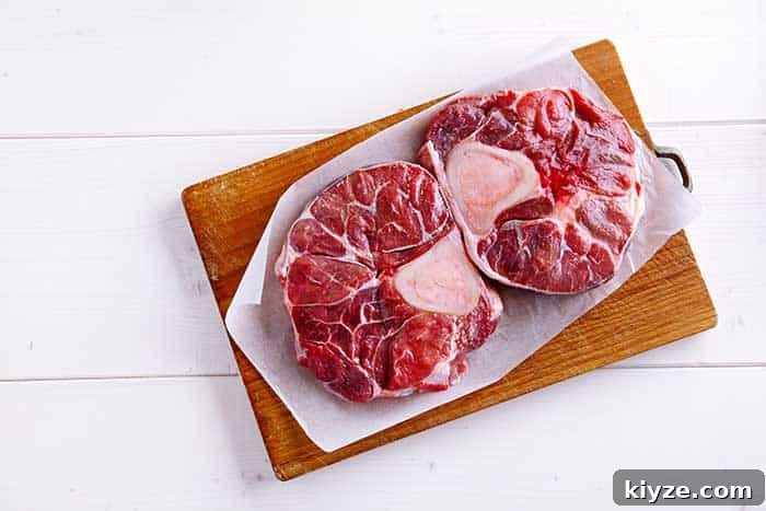Beef Shank Explained: Buying, Preparing, and Cooking Guide 4 raw beef shank cross cuts presented on parchment paper and wooden chopping board