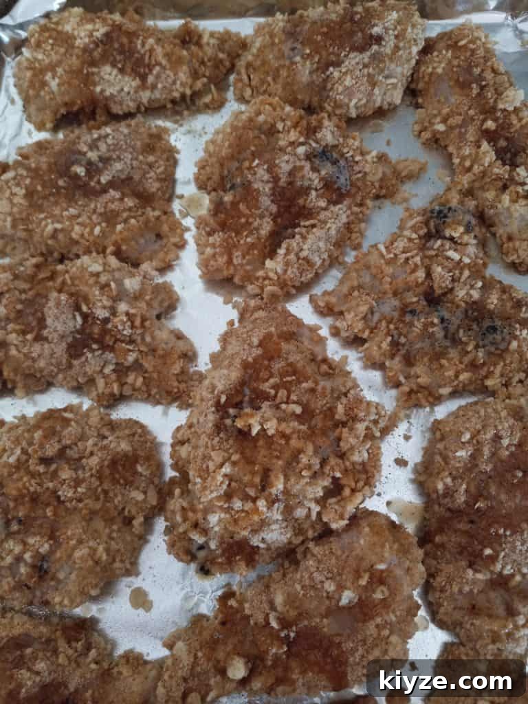 Rice Krispie chicken drizzled with butter and ready to bake.