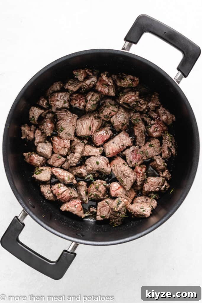 Hearty Beef Stew in Rich Tomato Sauce 5 Stew meat searing in a hot stock pot.