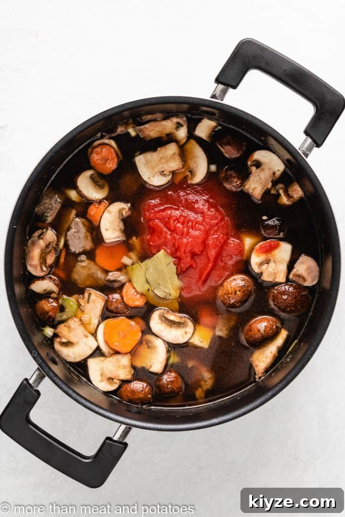 Hearty Beef Stew in Rich Tomato Sauce 8 Broth, bay leaves, and tomato sauce added to the pot.