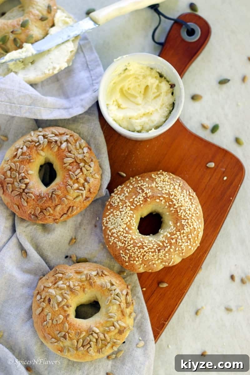 Homemade Bagels: A 5-Step Recipe for Perfect Chewy Bagels 4 3 bagels placed on a wooden board with cream cheese spread on the side