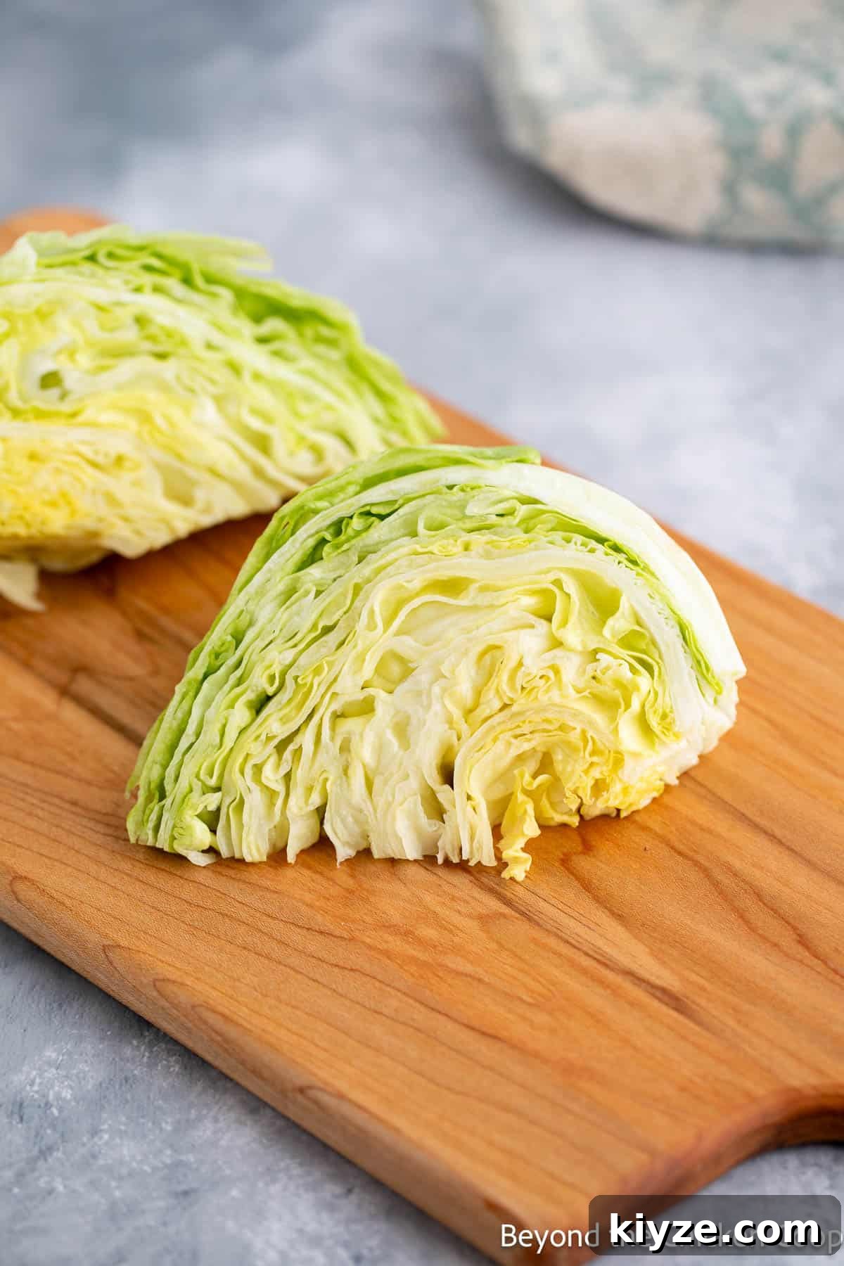 Classic Blue Cheese Wedge Salad with Crispy Bacon and Dressing 5 Wedges of iceberg lettuce on a cutting board.