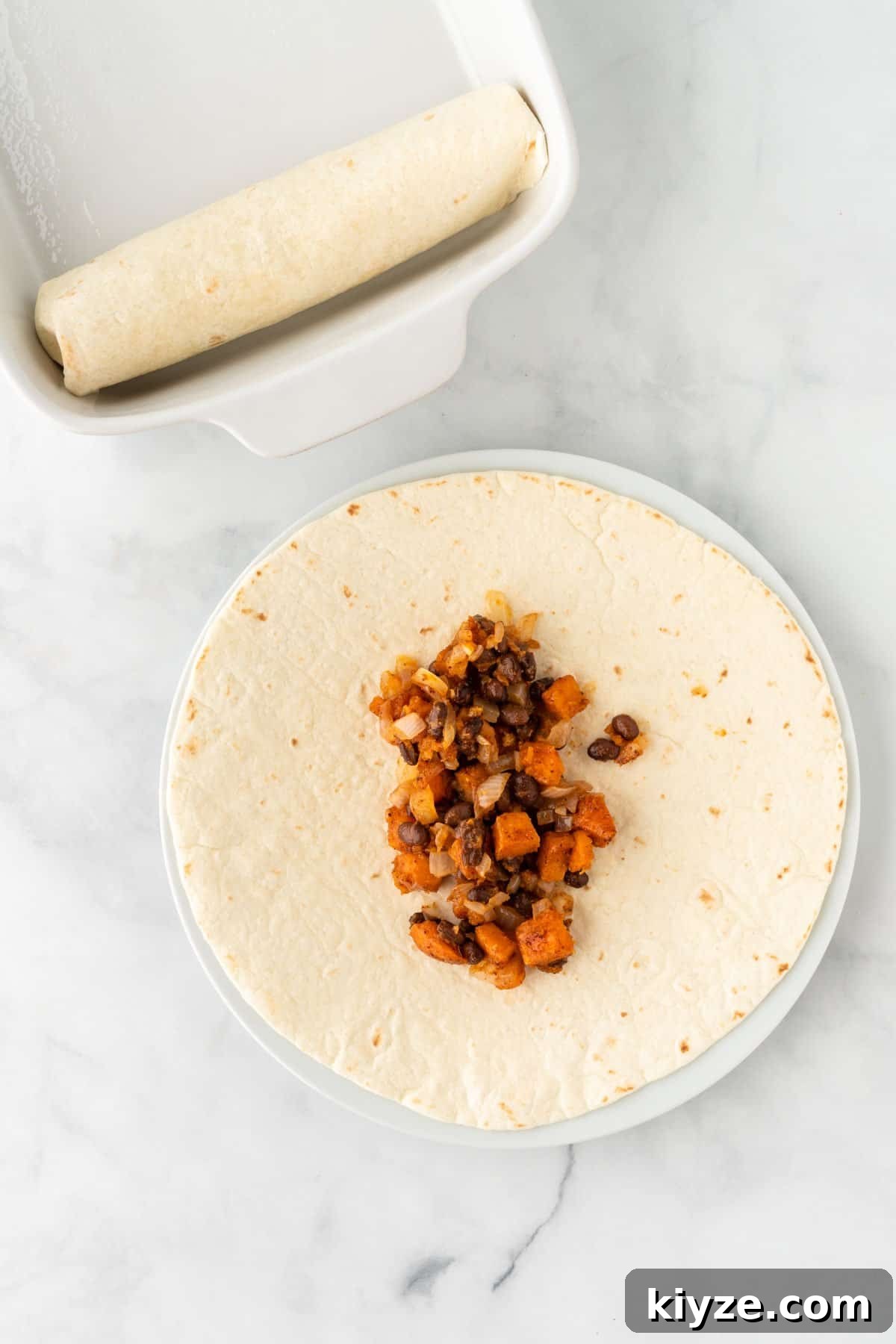 Sweet Potato and Black Bean Enchiladas with Chipotle Sauce 11 adding enchilada filling to a soft taco shell