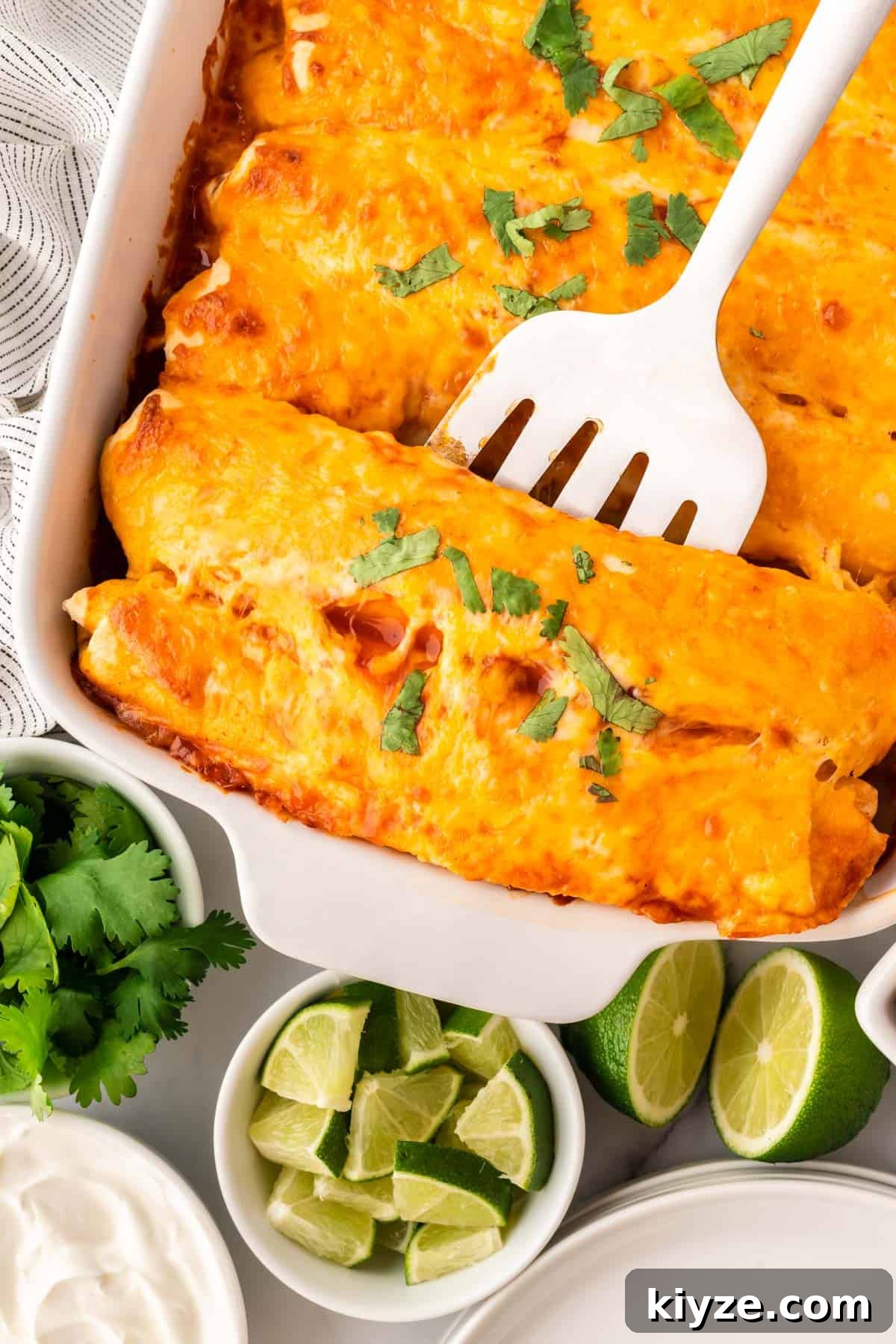 Sweet Potato and Black Bean Enchiladas with Chipotle Sauce 17 spatula scooping enchiladas from the pan