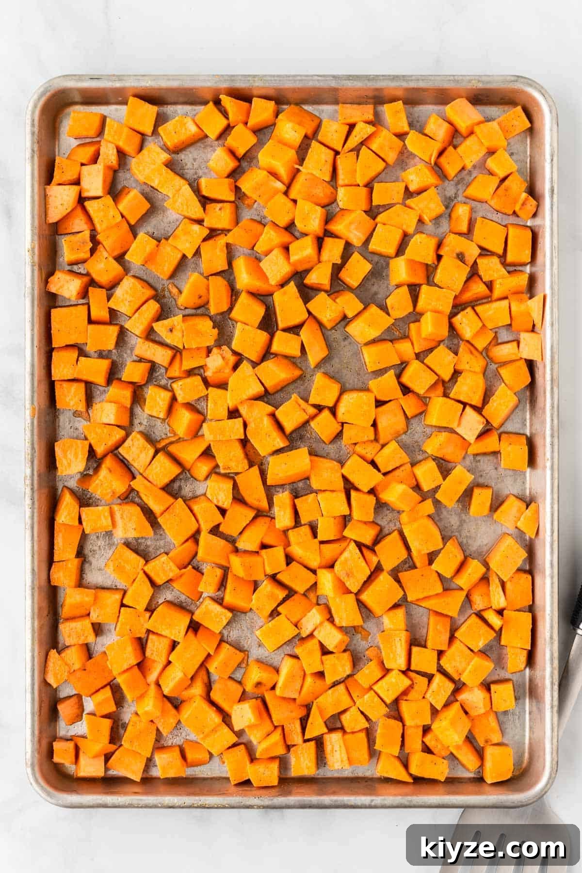 Sweet Potato and Black Bean Enchiladas with Chipotle Sauce 5 sweet potato cubes on a baking sheet