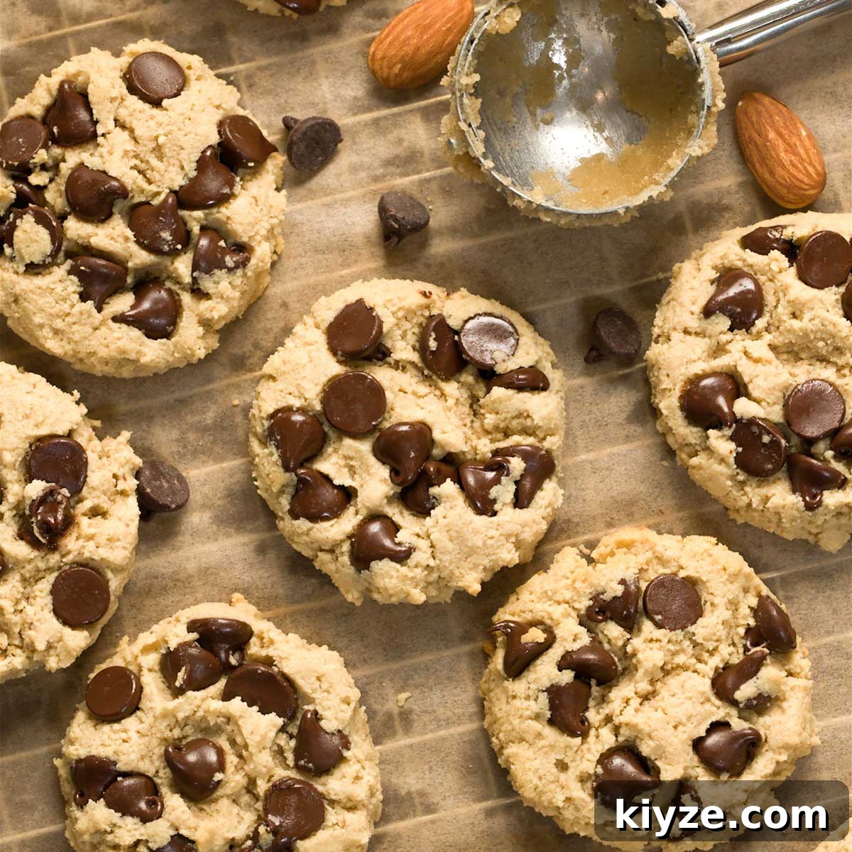 Almond Flour Chocolate Chip Cookies (Gluten-Free Recipe) 2 Gluten-free chocolate chip cookies on a cookie sheet.
