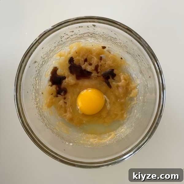 Almond Flour Chocolate Chip Cookies (Gluten-Free Recipe) 6 Adding wet ingredients to muffin batter.