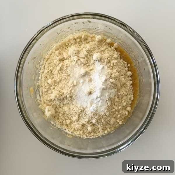Almond Flour Chocolate Chip Cookies (Gluten-Free Recipe) 7 Adding wet ingredients to muffin batter.