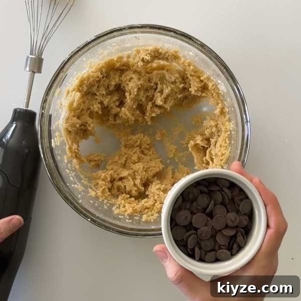Almond Flour Chocolate Chip Cookies (Gluten-Free Recipe) 8 Adding the chocolate chips to the cookie dough.