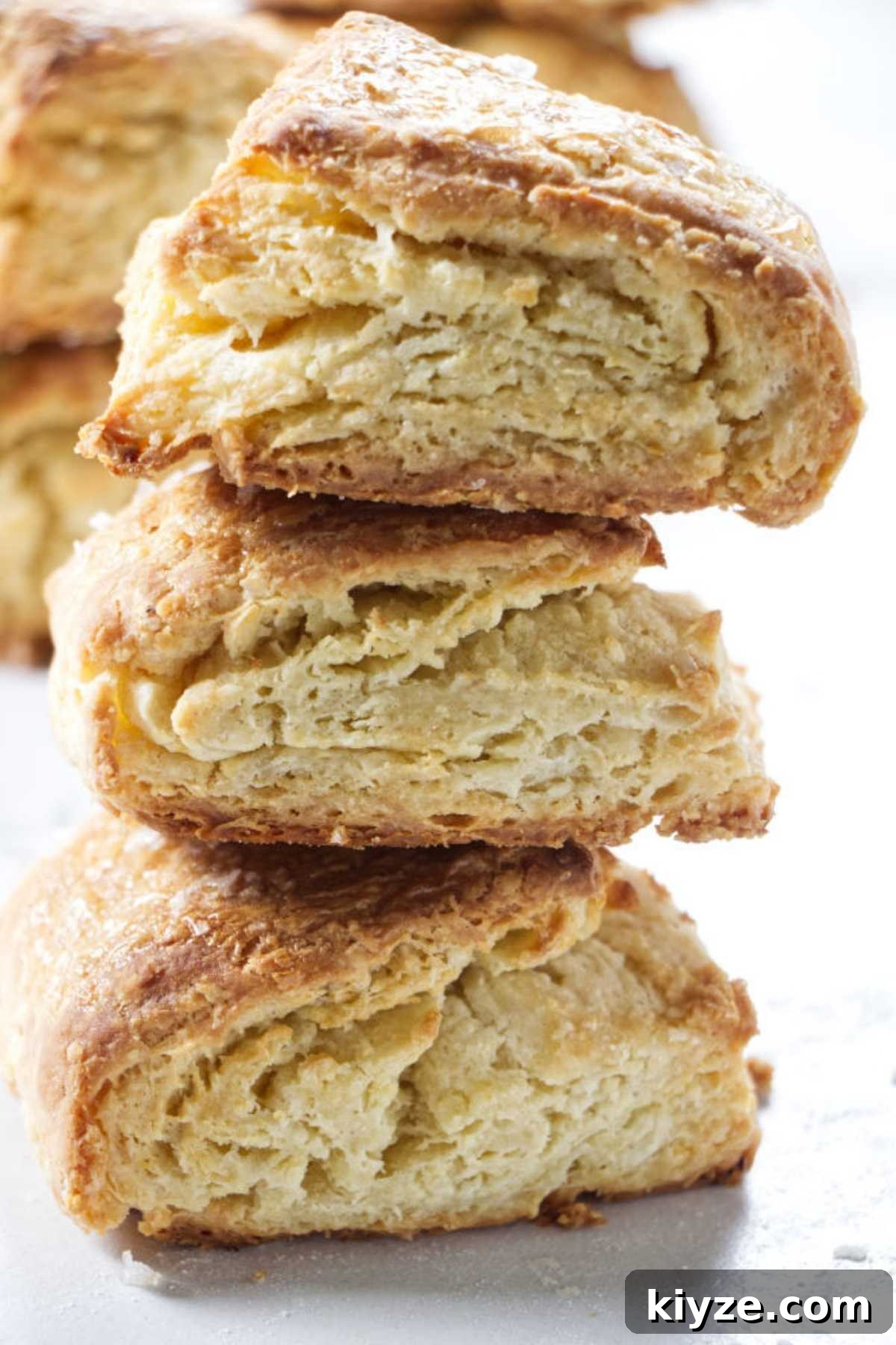 Flaky Sour Cream Biscuits Recipe for Perfect Homemade Biscuits 2 Stack of three sour cream biscuits on a counter.