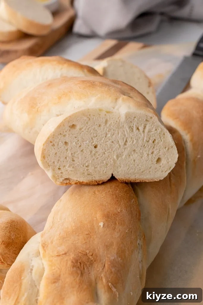 30-Minute Crusty Baguettes: Foolproof Recipe for Homemade Bread 12 two golden brown, baked loaves of french baguette sliced in half