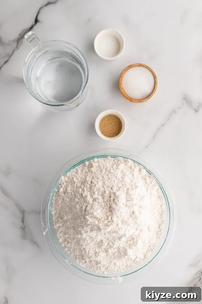 30-Minute Crusty Baguettes: Foolproof Recipe for Homemade Bread 4 overhead image showing the measured ingredients needed for a batch of crusty foolproof baguettes