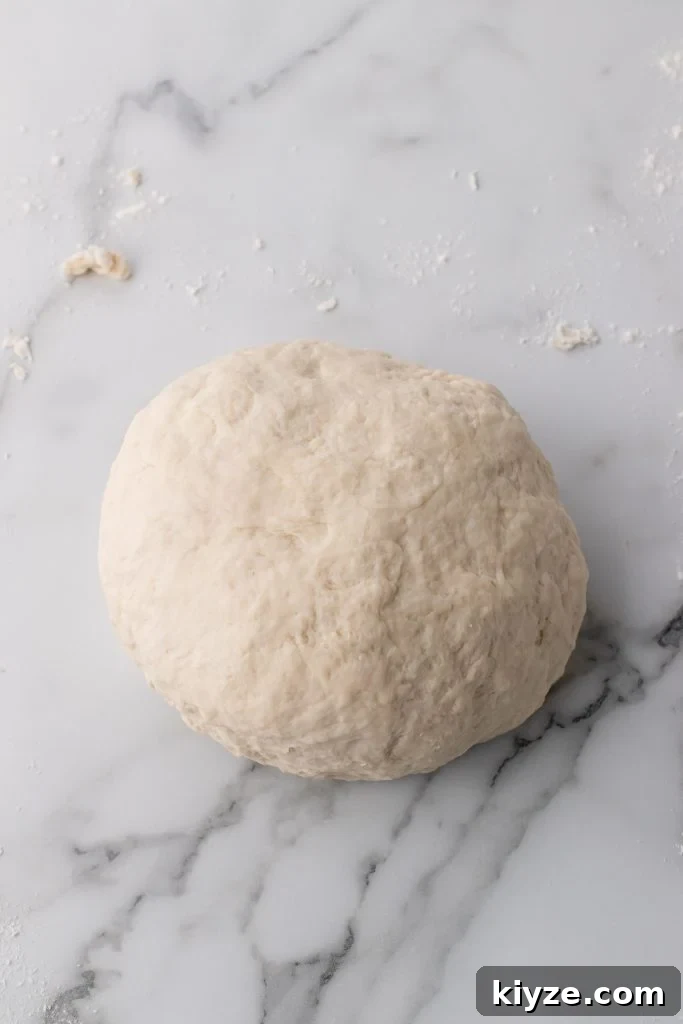 30-Minute Crusty Baguettes: Foolproof Recipe for Homemade Bread 7 foolproof baguette dough ball on a marble countertop