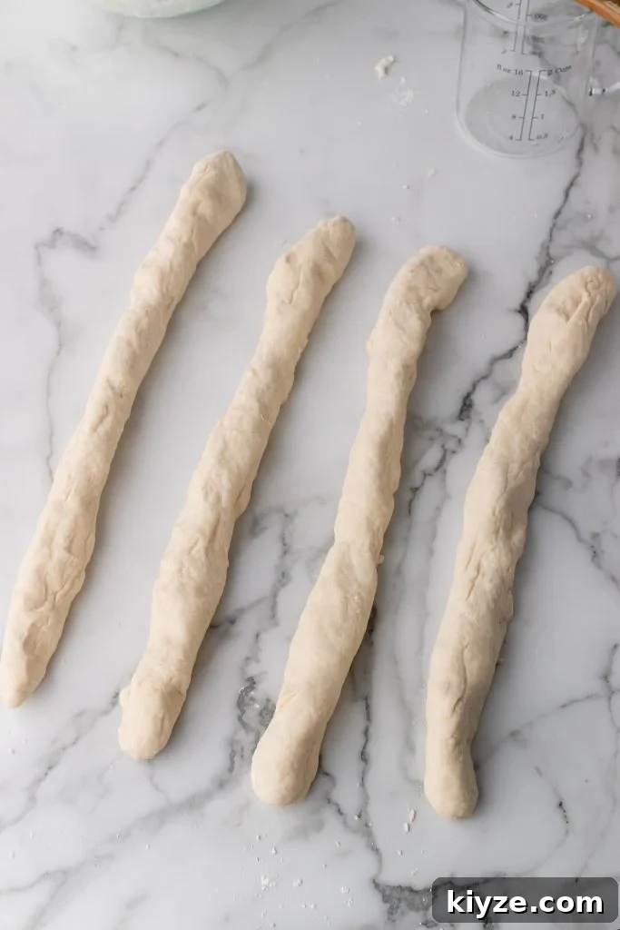 30-Minute Crusty Baguettes: Foolproof Recipe for Homemade Bread 9 4 long even ropes of french baguette dough
