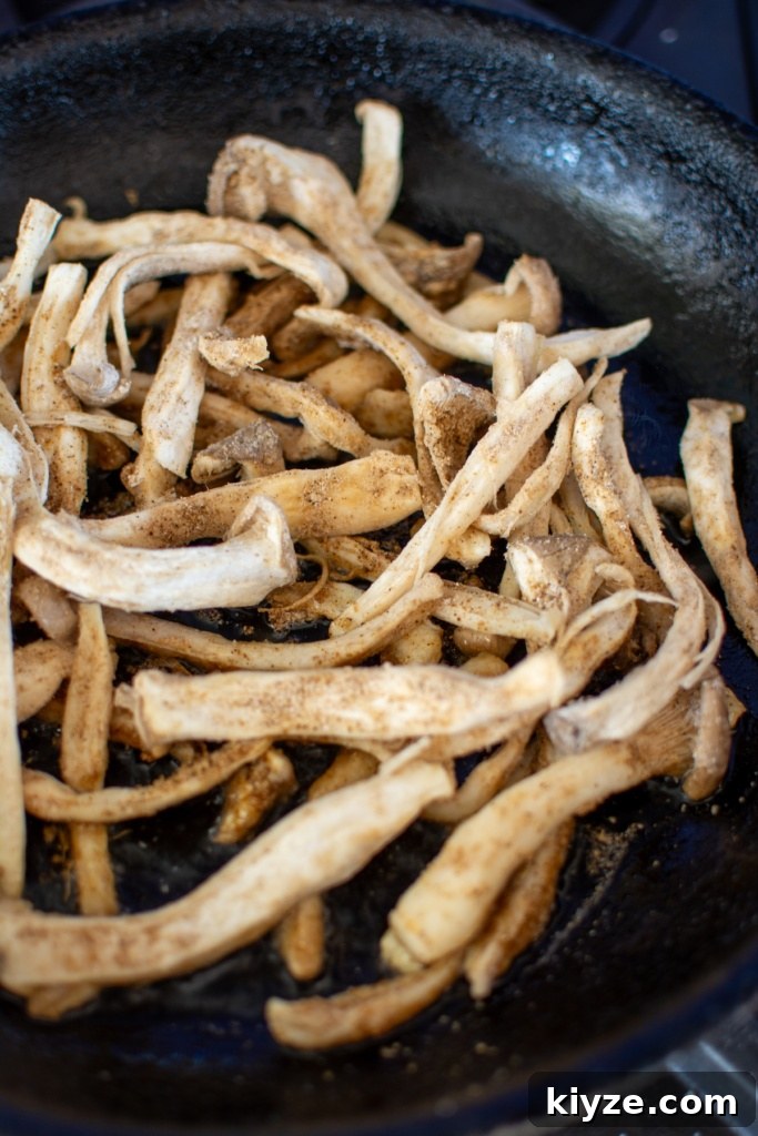 Vegan Oyster Mushroom Carnitas Tacos — Smoky Plant-Based Filling 7 oyster mushrooms cooking in a pan