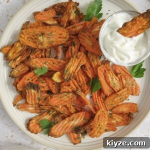 Crispy Air Fryer Carrot Chips Recipe 9 air fryer carrot chips on a plate with parsley