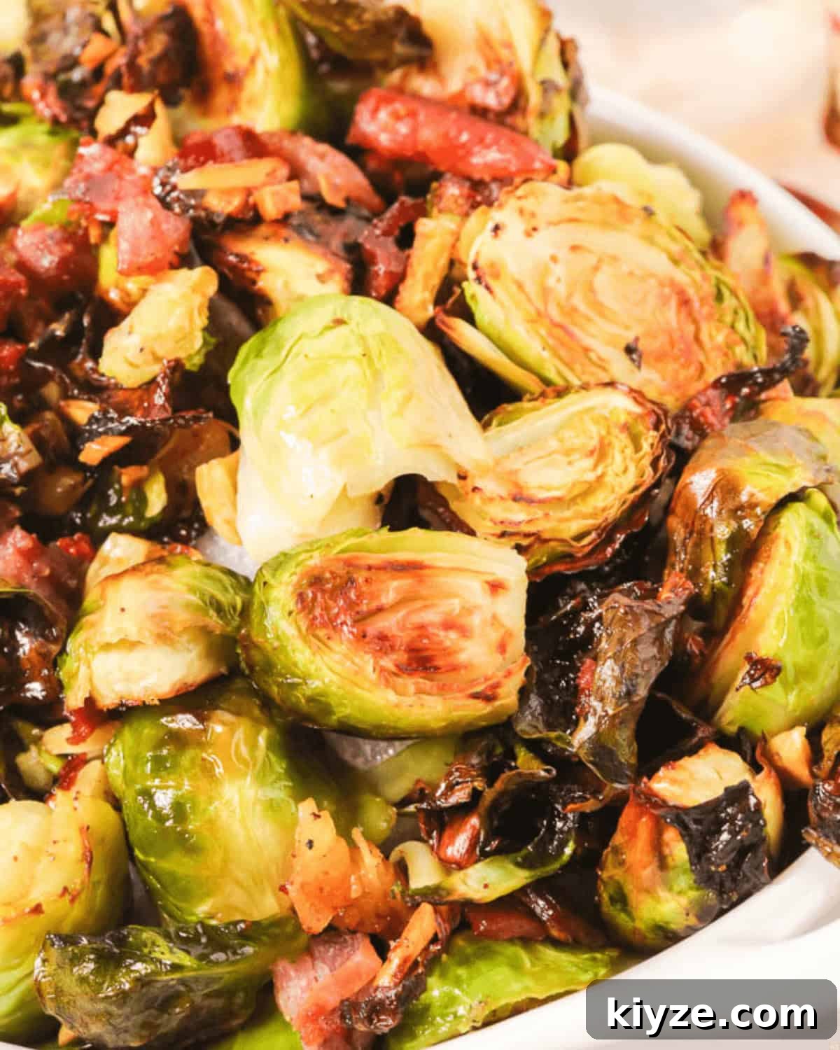 Crispy Roasted Brussels Sprouts with Prosciutto and Balsamic Glaze 2 A closeup top shot of the crussel sprouts with prosciutto.