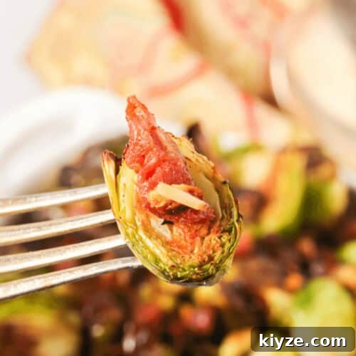Crispy Roasted Brussels Sprouts with Prosciutto and Balsamic Glaze 7 A fork with a vegetables on it.