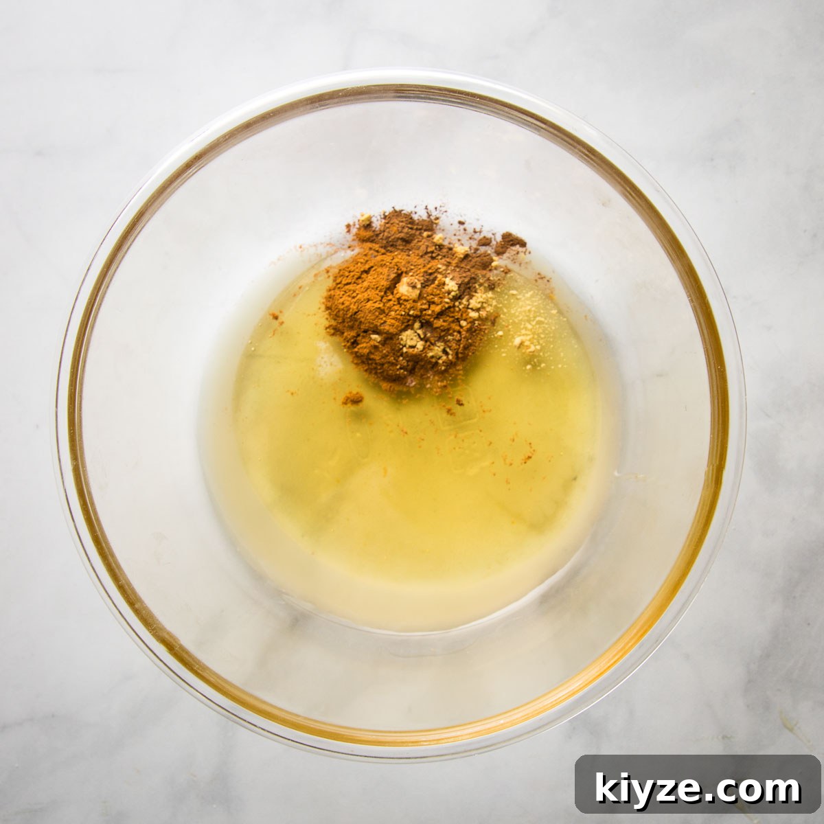 Spices, lemon juice and honey in a large glass bowl.