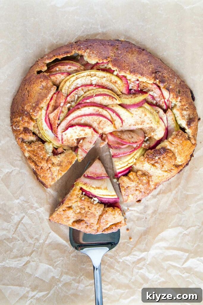 Apple galette with a slice on a serving piece.