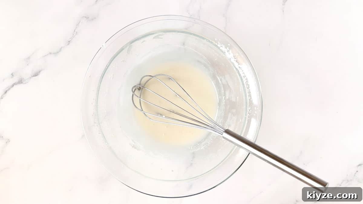 Bunny-Shaped Cinnamon Rolls: Cute Recipe for Spring Brunch 14 making icing in a bowl