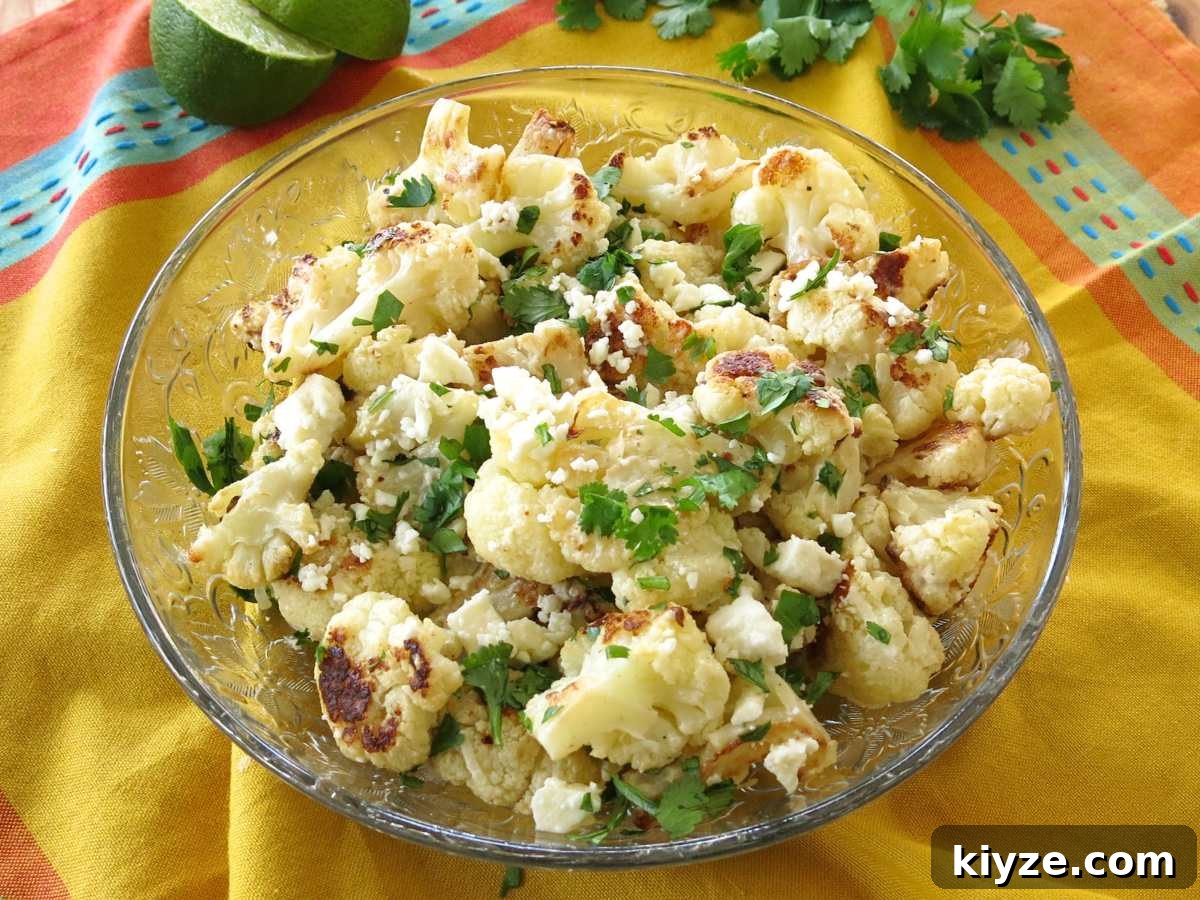 Glass bowl with street style cauliflower on a yellow napkin.
