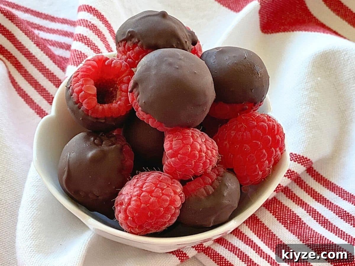 White bowl with chocolate covered raspberries.