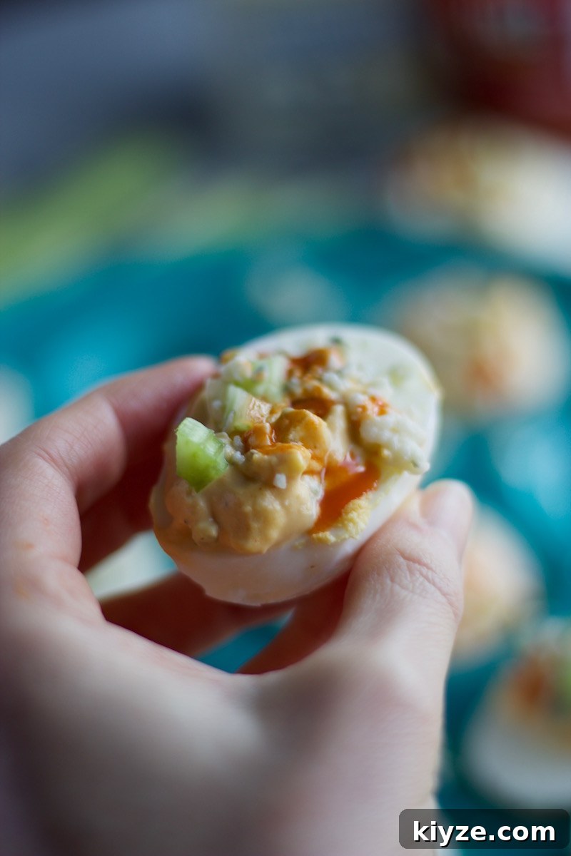 Spicy Buffalo Deviled Eggs Recipe for Game Day and Parties 13 Buffalo Deviled Eggs - a kicked up deviled egg, featuring blue cheese, celery, and of course, hot sauce! | fedandfulfilled.com
