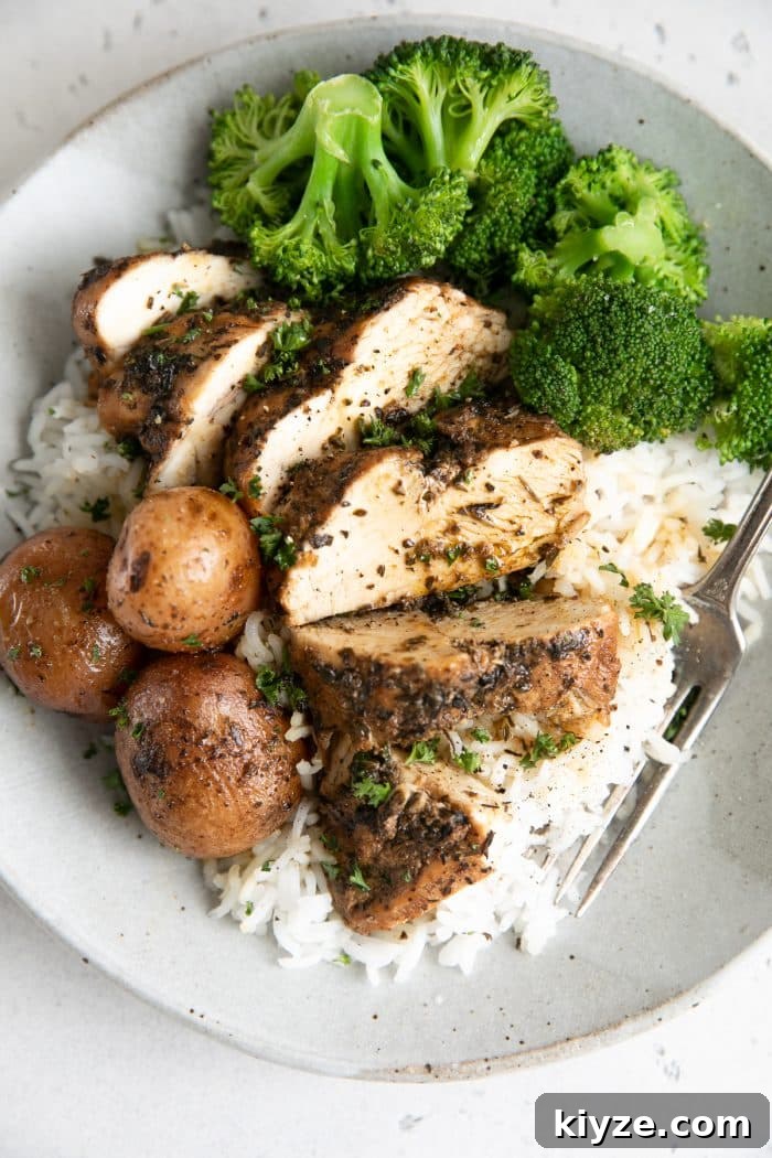 Instant Pot Chicken and Potatoes Dinner Recipe 2 Sliced chicken breast and potatoes served over rice with cooked broccoli.