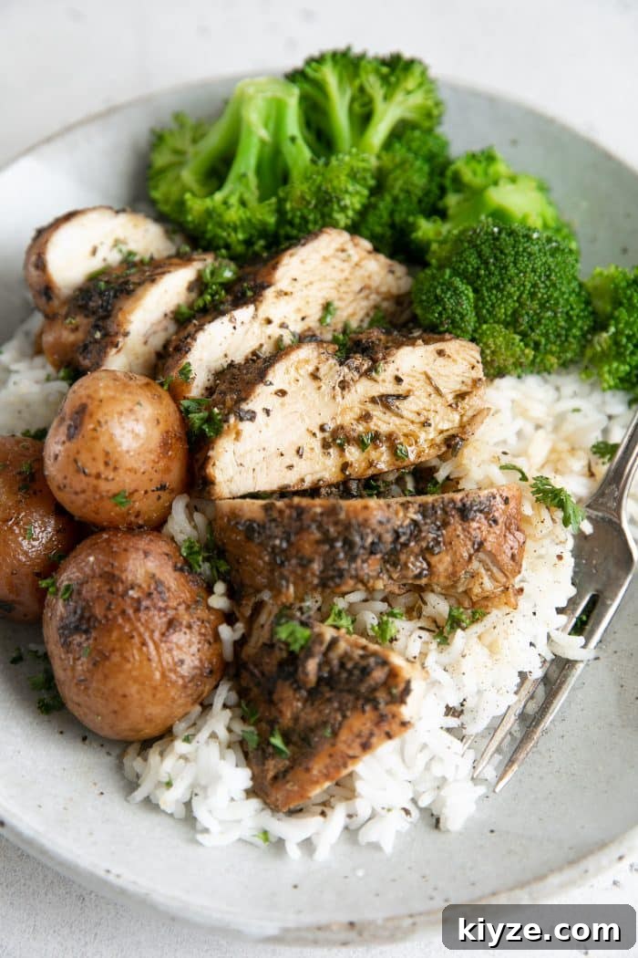 Instant Pot Chicken and Potatoes Dinner Recipe 7 Sliced chicken breast and potatoes served over rice with cooked broccoli.