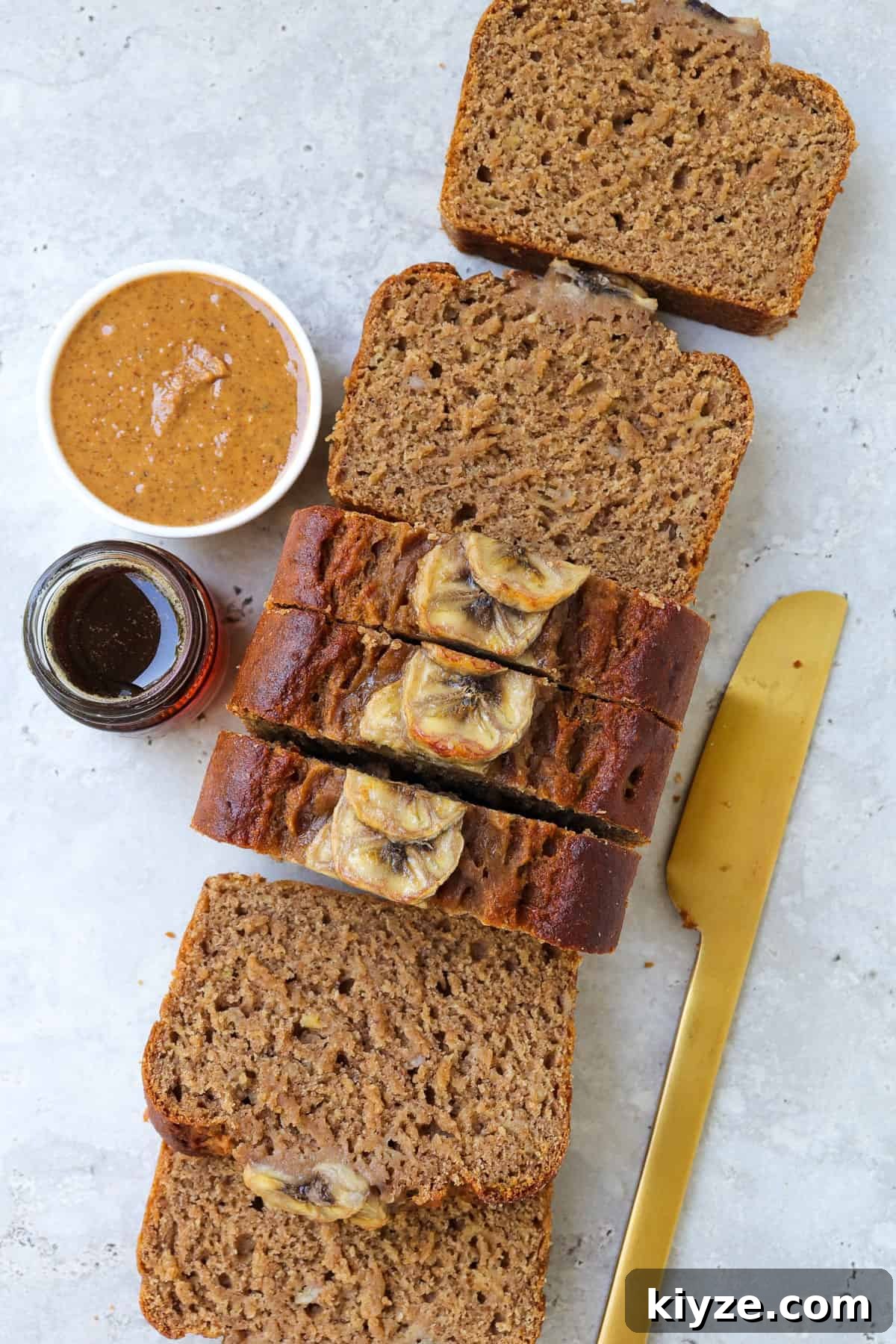 5-Ingredient Vegan Banana Bread Recipe 9 Close up shot of bread sliced on sides.