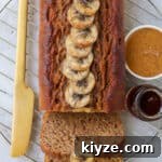 Easy 5 ingredient vegan banana bread made with almond butter and spelt flour. Naturally sweetened and oil-free, it's the perfect treat to have on hand for a quick breakfast or healthy snack.