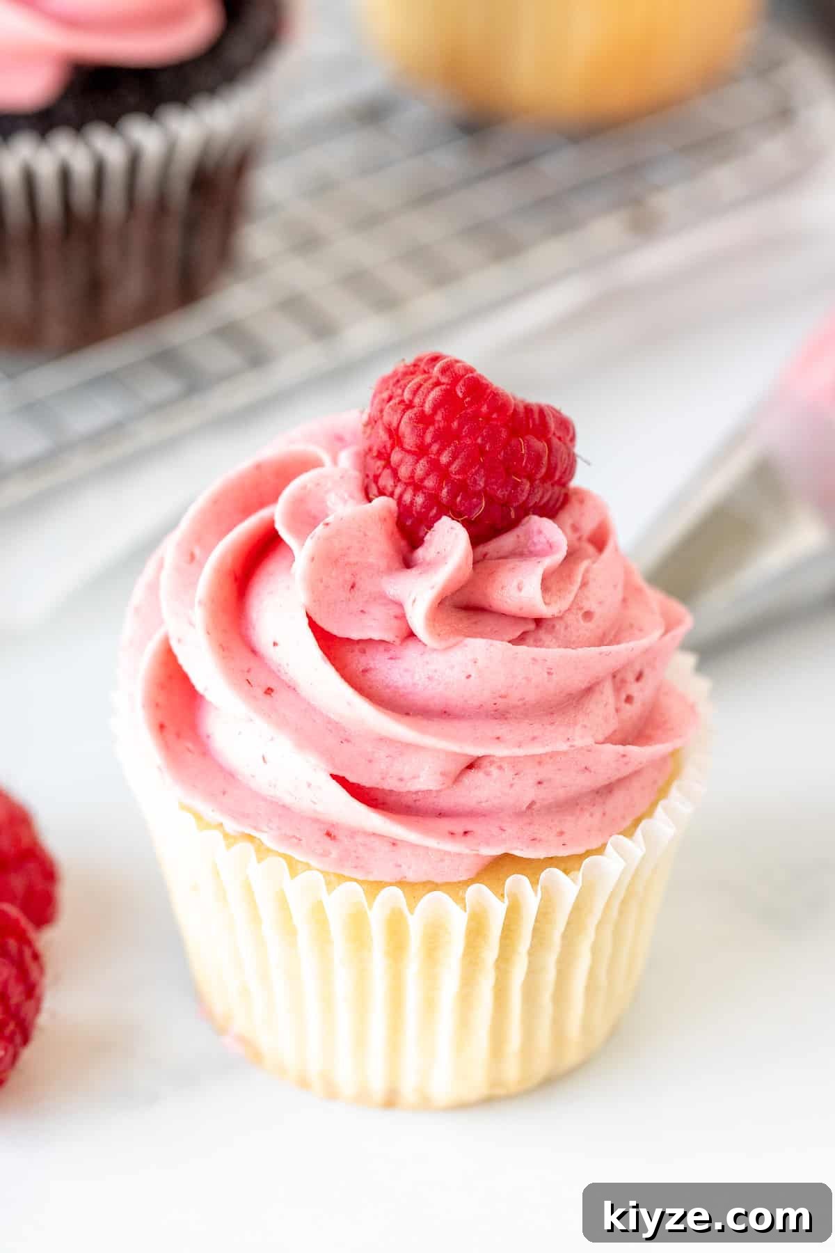 Raspberry Buttercream Frosting with Fresh or Frozen Berries 2 Vanilla cupcake decorated with raspberry frosting