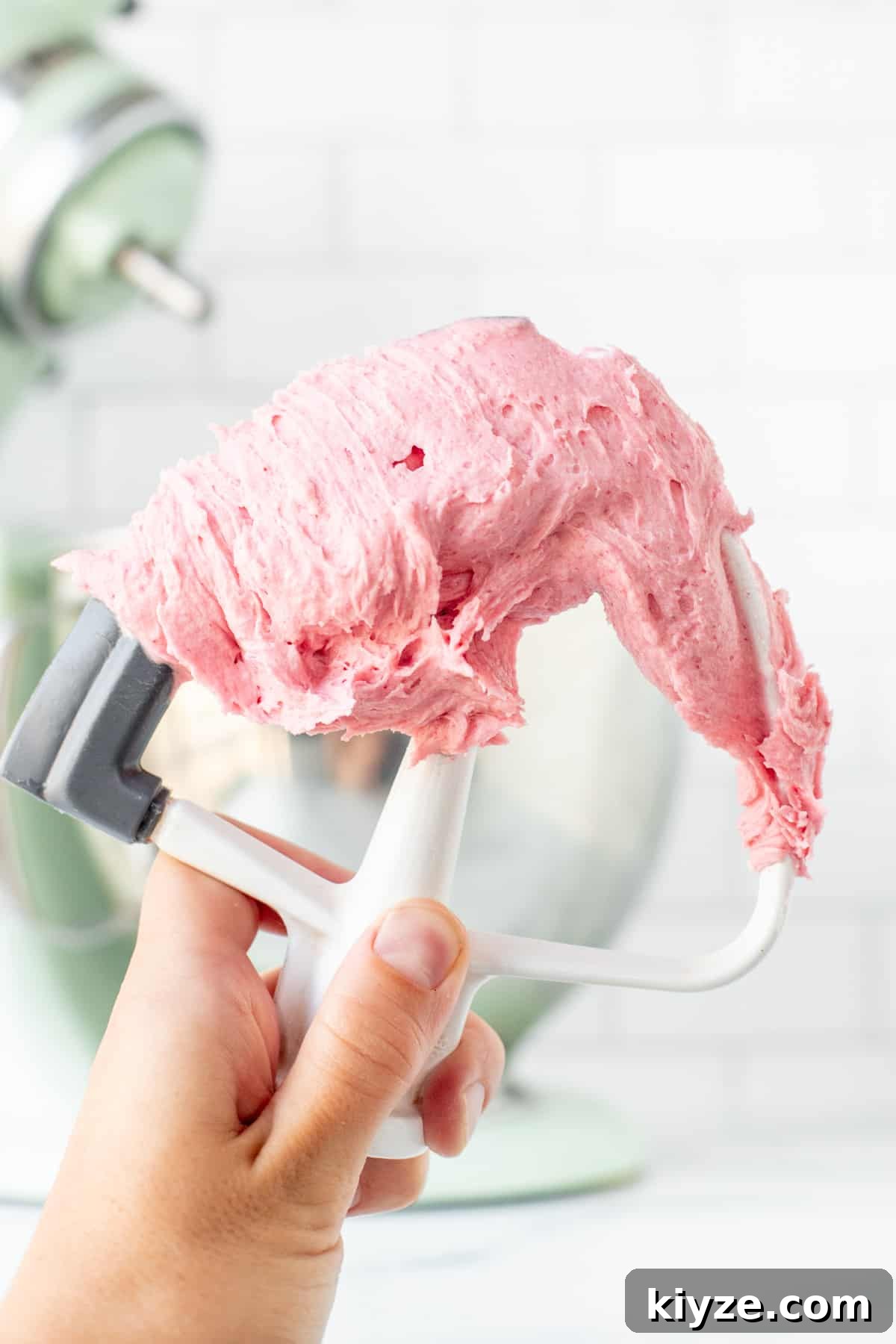 Raspberry Buttercream Frosting with Fresh or Frozen Berries 5 Kitchen beater with pink raspberry buttercream on it